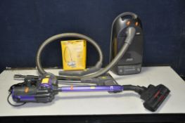 A MIELE BLACK DIAMOND VACUUM CLEANER with hose and floor attachment along with a partial box of bags