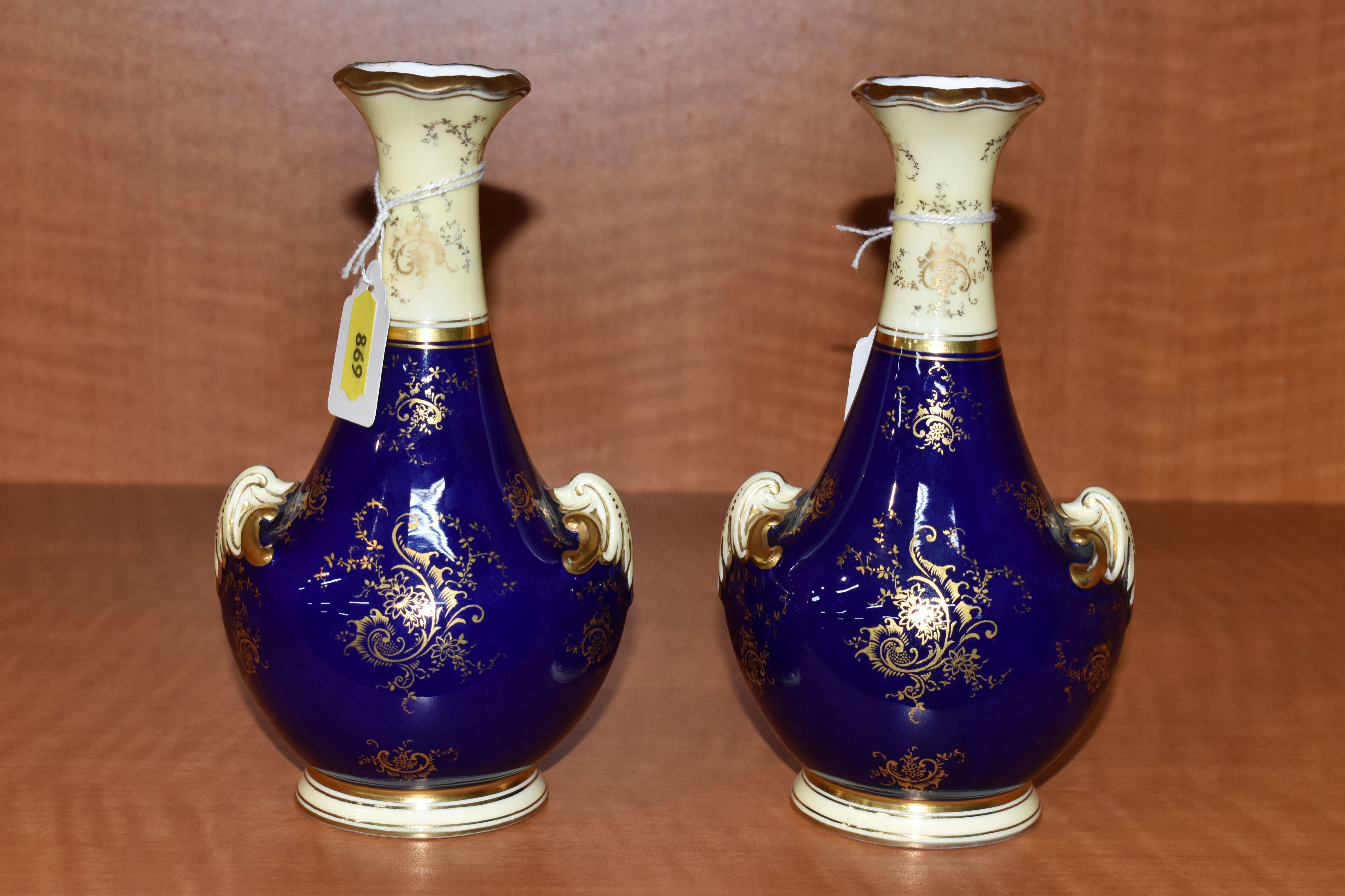 A PAIR OF EARLY 20TH CENTURY COALPORT BALUSTER VASES, blue, pale yellow and gilt ground, each hand - Image 5 of 8