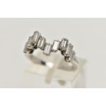 AN 18CT WHITE GOLD DIAMOND RING, designed with a wavy row of nine baguette cut diamonds, each in a