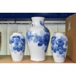 THREE JAPANESE OKURA PORCELAIN VASES, decorated with blue roses on a white ground, heights 22cm,