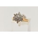 AN 18CT GOLD DIAMOND CLUSTER RING, flower shape cluster ring set with a central round brilliant