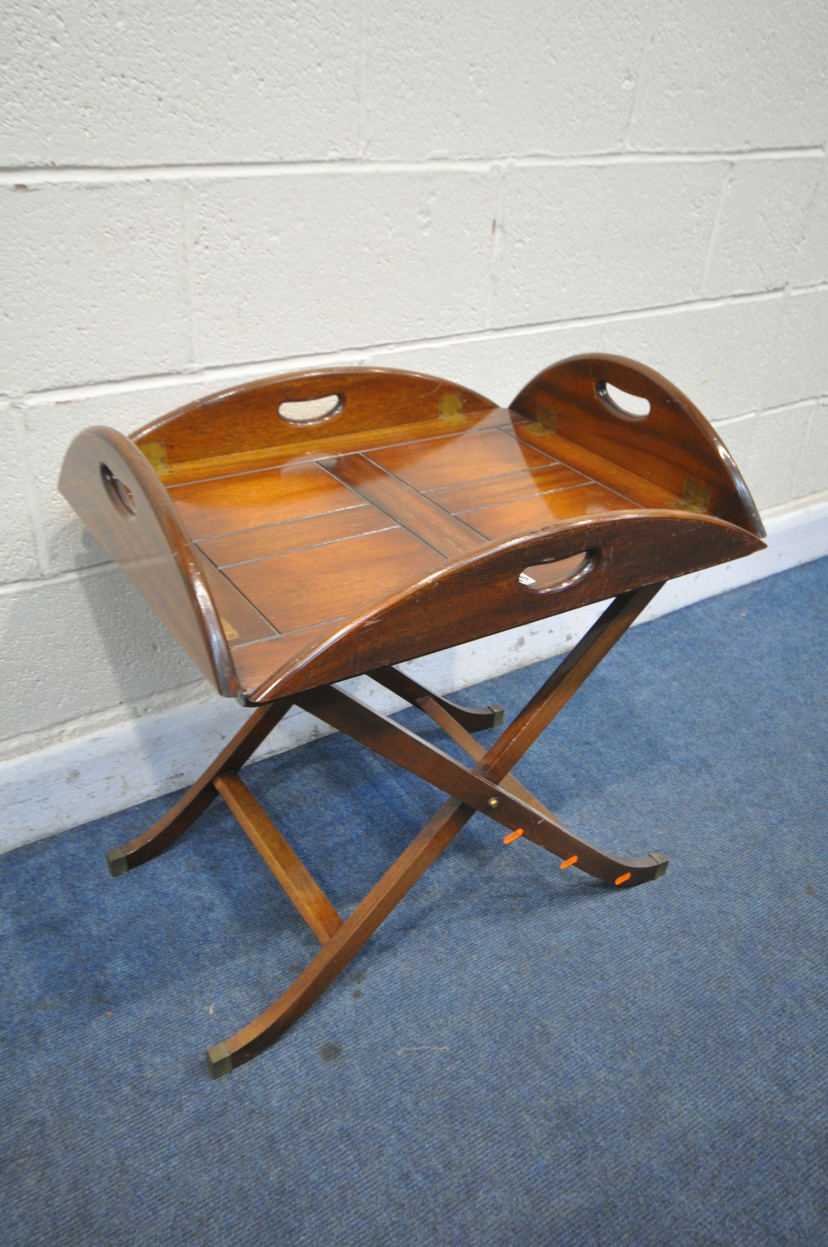 A MAHOGANY BUTLERS TRAY, with hinged sides on a folding base (condition:- surface scratches)