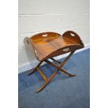 A MAHOGANY BUTLERS TRAY, with hinged sides on a folding base (condition:- surface scratches)