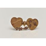 A YELLOW METAL SWEETHEART BROOCH, designed as two hearts with a bow and ivy leaf detail,