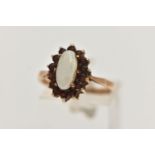 A 9CT GOLD CLUSTER RING, of an oval form, set with a central opal cabochon, in a surround of