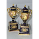 A PAIR OF VIENNA STYLE PORCELAIN TWIN HANDLED PEDESTAL VASES WITH COVERS, cobalt blue and gilt