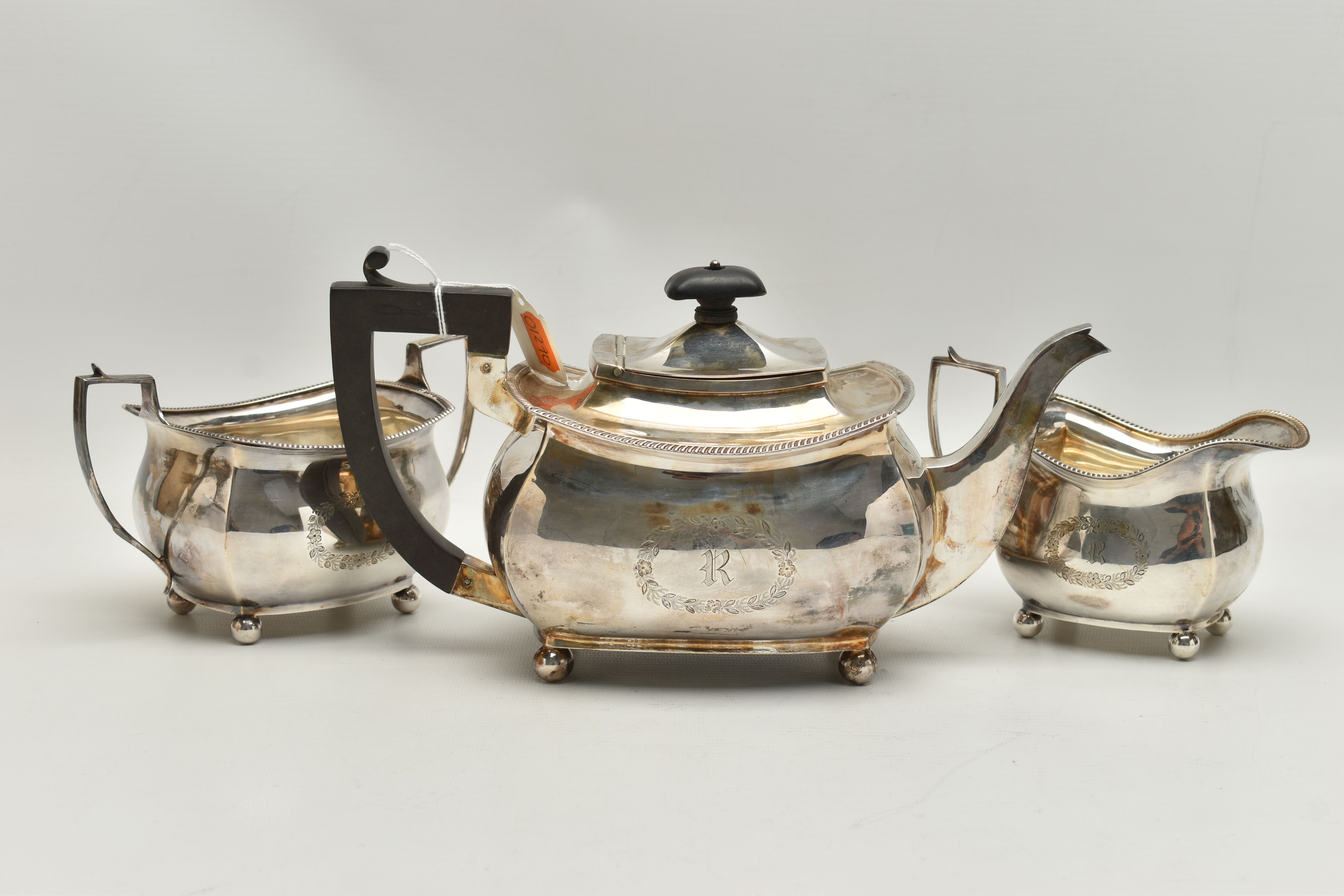 A GEORGE V THREE PIECE SILVER TEA SET, comprising of a polished teapot with engraved initial 'R' - Image 2 of 7