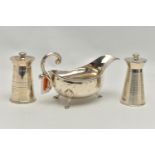 AN ELIZABETH II SILVER SAUCE BOAT AND TWO ELIZABETH II SILVER MILK CHURN SHAPED PEPPERMILLS, the