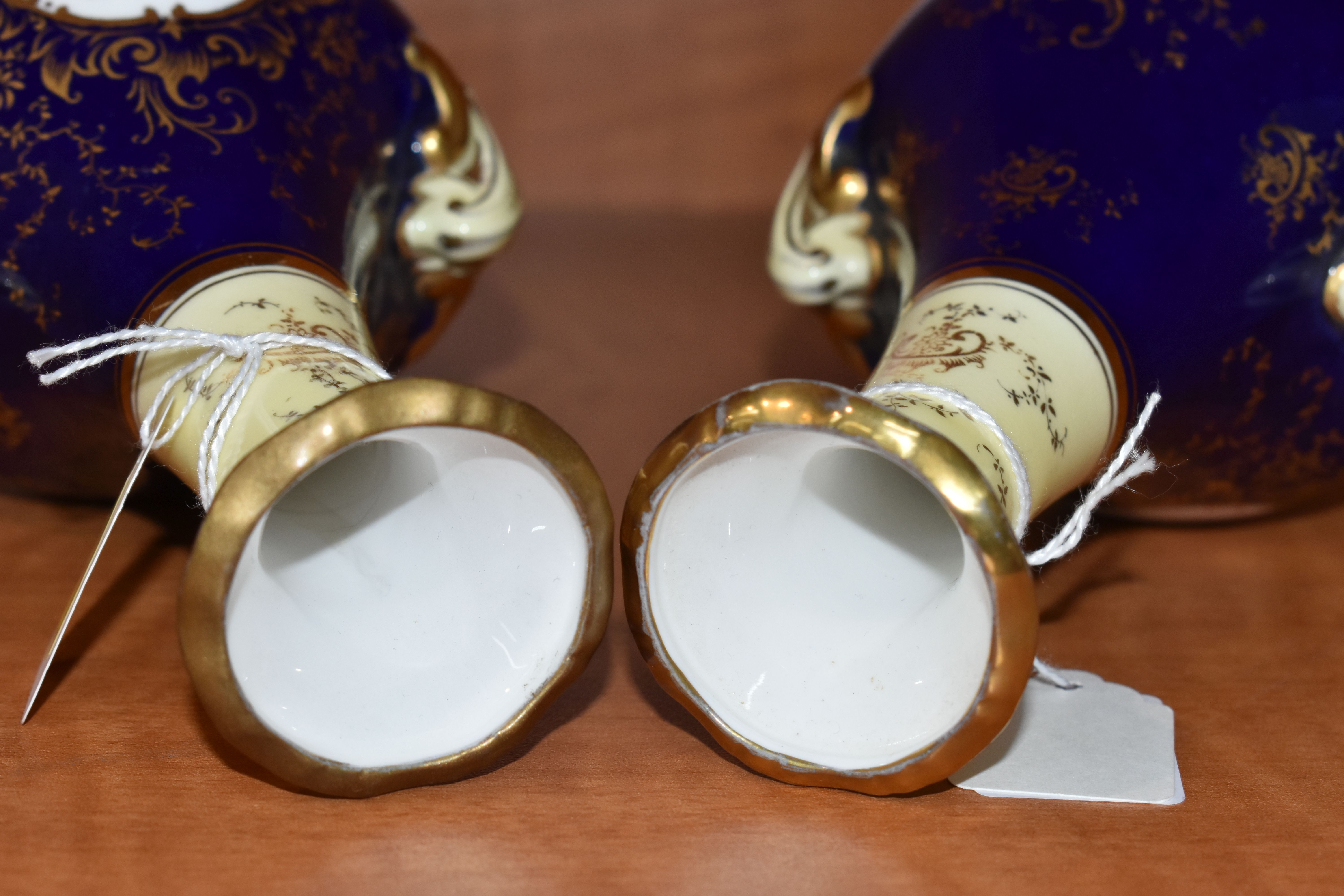 A PAIR OF EARLY 20TH CENTURY COALPORT BALUSTER VASES, blue, pale yellow and gilt ground, each hand - Image 7 of 8