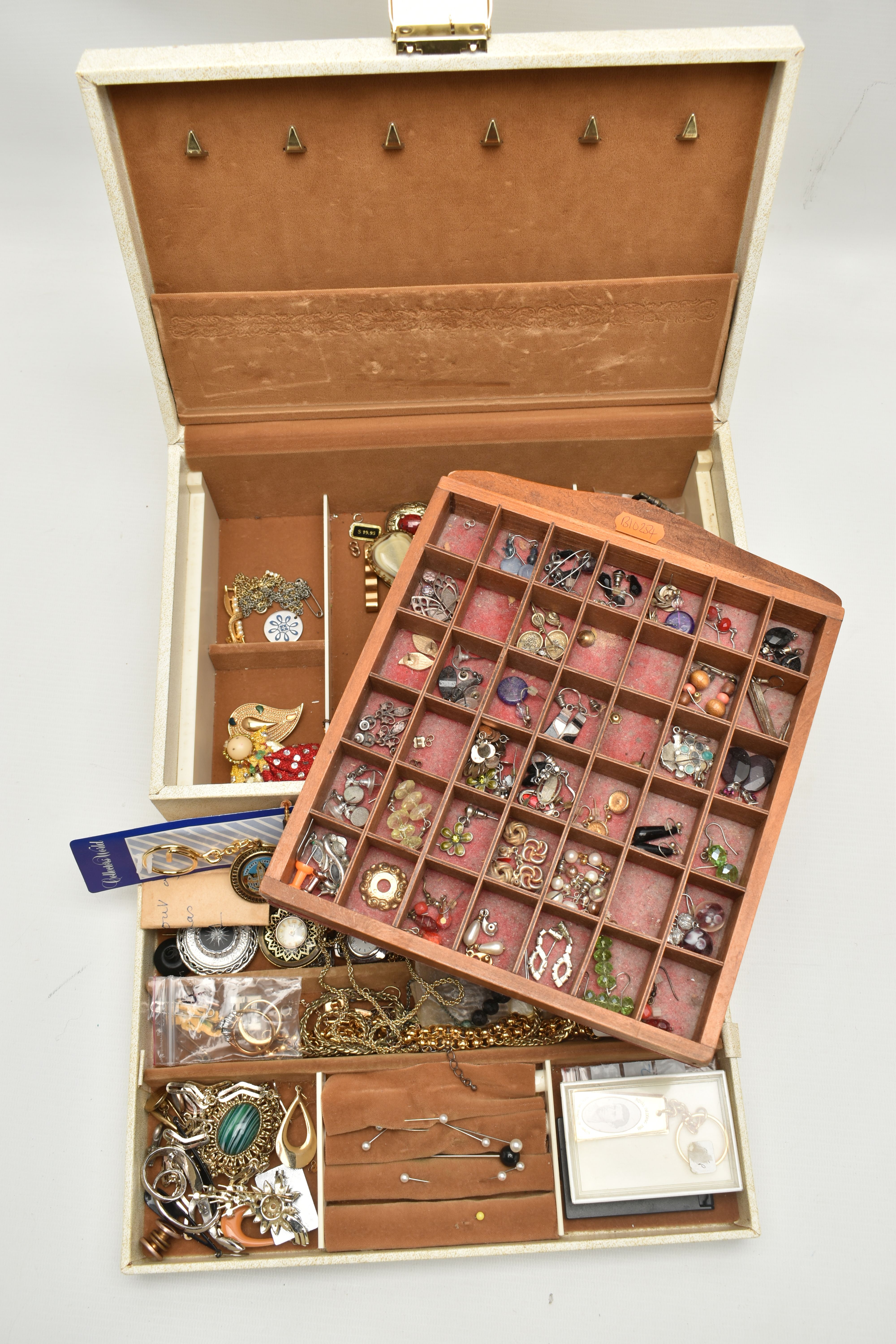 A JEWELLERY BOX WITH CONTENTS AND A WOODEN TRAY OF EARRINGS, the cream jewellery box containing