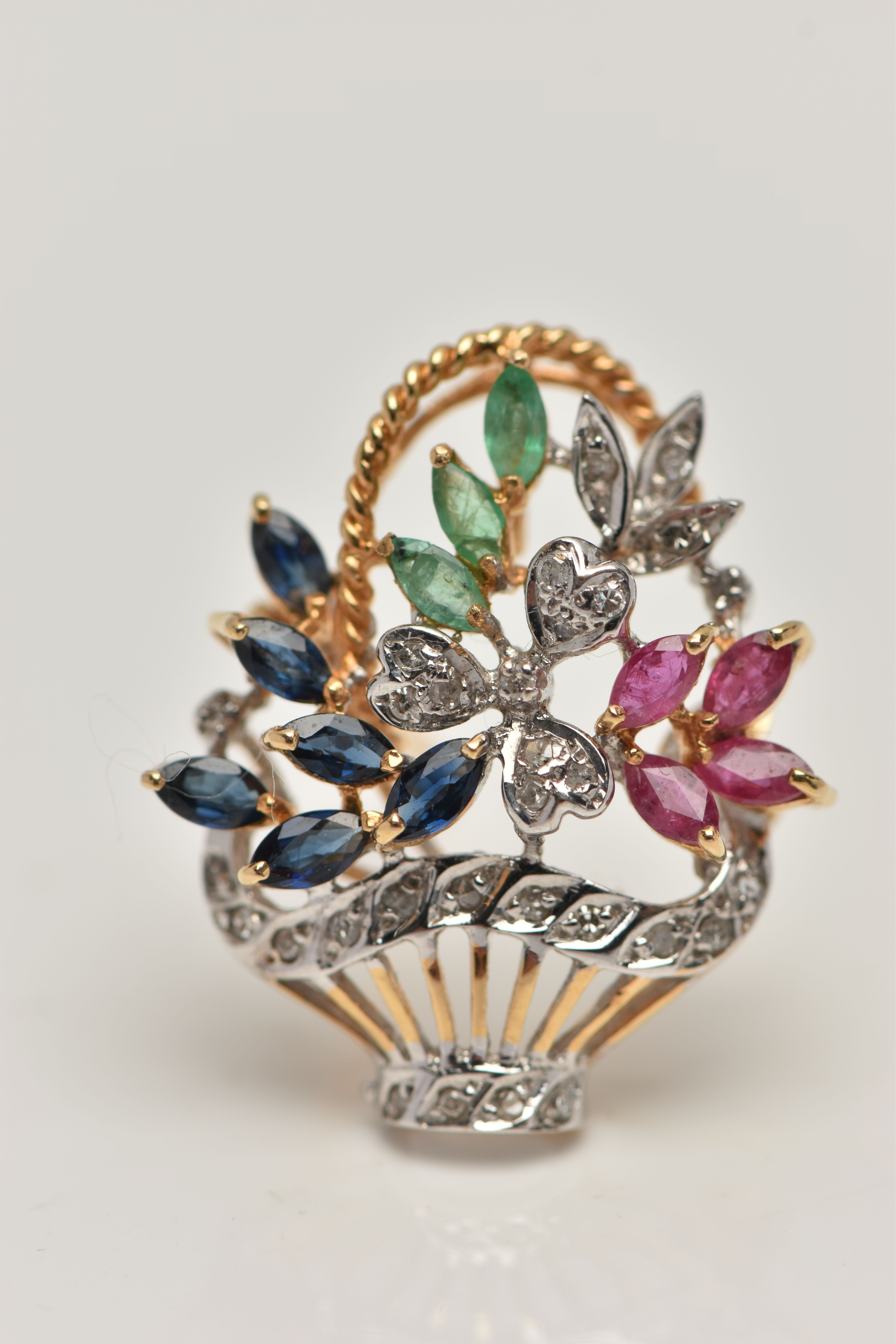 A GEM SET FLOWER BASKET BROOCH, yellow and white metal brooch set with four marquise cut rubies,