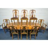 A EARLY 20TH CENTURY WALNUT WINDOUT DINING TABLE, with rounded ends, two additional leaves on four