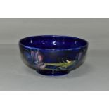A MOORCROFT POTTERY 'ANEMONE' BOWL, tube lined with red and purple anemones on a dark blue ground,