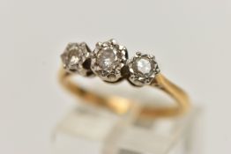 A YELLOW METAL THREE STONE DIAMOND RING, three round brilliant cut diamonds illusion set in a