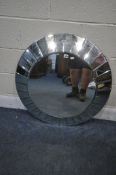 AN RV ASTLEY CIRCULAR BEVELLED EDGE WALL MIRROR, surrounded by bevelled mirror segments, diameter