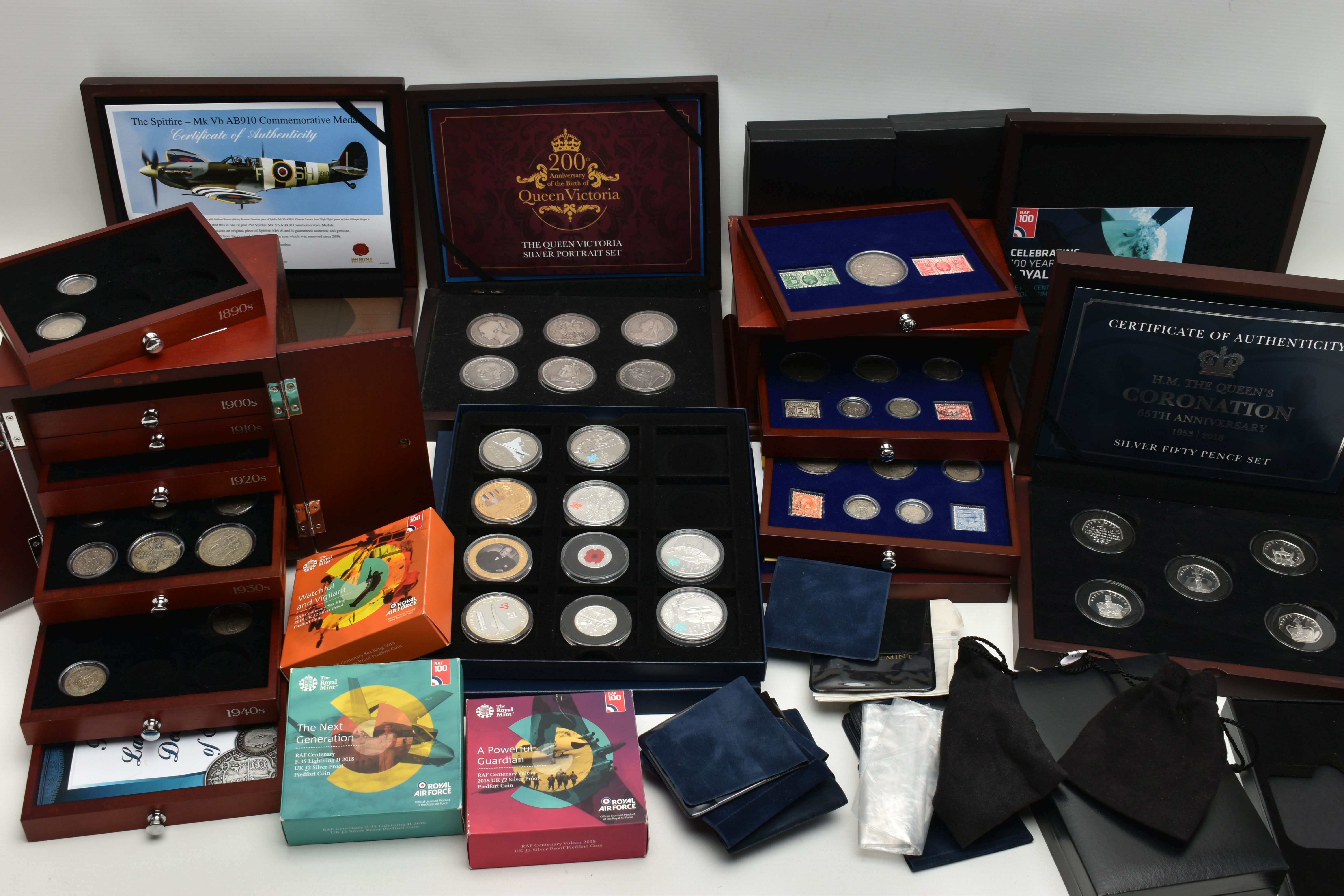 A GLAZED DISPLAY BOX THREE DECADES of GEORGE V STAMP AND COIN SET, to include four trays of silver