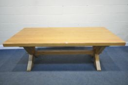 AN HEAVY GOOD QUALITY LIGHT OAK REFECTORY TABLE, on a X trestle base united by a block stretcher,