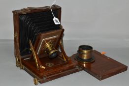 AN O.F.S.ROTHWELL MAHOGANY AND BRASS FIELD CAMERA with a replacement lens plate holding a Busch's