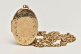 A 9CT GOLD LOCKET AND CHAIN, oval locket with floral detail to the front, opens to reveal two
