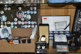 A COLLECTION OF ELVIS MEMORABILIA, including approximately sixty badges within a stained pine frame,