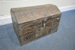 A CARVED HARDWOOD TRIBAL DOMED TOPPED CHEST, width 60cm x depth 37cm x height 39cm (condition:-