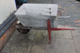A VINTAGE WOODEN WHEELBARROW with replacement aluminium bucket fitted to old framework, modern wheel