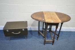 A SMALL OAK BARLEY TWIST OVAL GATE LEG TABLE, along with a sewing machine case, on hairpin legs (