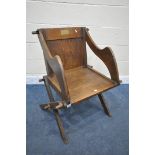 AN EARLY 20TH CENTURY OAK GLASTONBURY CHAIR, with a brass presentation plaque reading J T Whittaker,