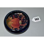 A SMALL BLUE MOORCROFT 'POMEGRANATE' PATTERN DISH, diameter 11cm, impressed marks to base (1) (