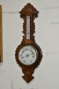A VICTORIAN OAK CASED ANEROID BAROMETER, heavily carved with a mercury thermometer, height 86cm x