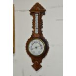 A VICTORIAN OAK CASED ANEROID BAROMETER, heavily carved with a mercury thermometer, height 86cm x