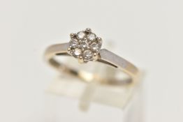 A WHITE GOLD DIAMOND CLUSTER RING, small cluster of seven round brilliant cut diamonds, stamped