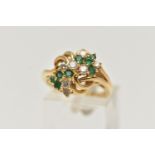 AN 18CT GOLD, DIAMOND AND EMERALD DRESS RING, asymmetrical design set with seven round brilliant cut