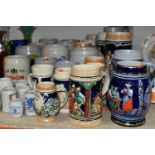 A COLLECTION OF STEINS AND CERAMIC TANKARDS, thirty two pieces to include salt glazed stoneware