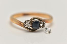 A YELLOW METAL GEM SET RING, three stone mount set with a square cut sapphire and one single cut