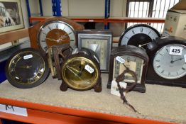 A GROUP OF CLOCKS, comprising four 1930's Smith Sectric clocks, a Temco Bakelite electric clock by