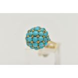 A YELLOW METAL TURQUOISE DOME RING, circular dome set with turquoise cabochons, raised on an open