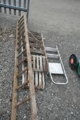 FOUR VARIOUS SETS OF LADDERS, to include one aluminium step ladder, two wooden step ladders, and a