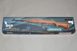 A BOXED ELECTRICALLY POWERED BB COPY OF A M1 CARBINE, model number D69, bearing no makers name or