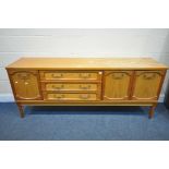 A MID CENTURY TEAK SIDEBOARD, with an arrangement of drawers and cupboard doors, on cylindrical