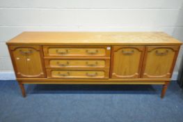 A MID CENTURY TEAK SIDEBOARD, with an arrangement of drawers and cupboard doors, on cylindrical