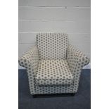 A MODERN SPOTTED UPHOLSTERED ARMCHAIR, length 88cm