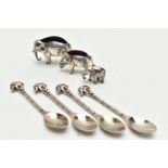AN EDWARDIAN SILVER ELEPHANT PIN CUSHION, TWO OTHERS AND FOUR SPOONS, realistically stylised