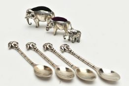 AN EDWARDIAN SILVER ELEPHANT PIN CUSHION, TWO OTHERS AND FOUR SPOONS, realistically stylised