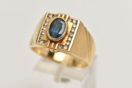 A GENTS YELLOW METAL SAPPHIRE AND DIAMOND SIGNET RING, set with a central oval cut blue sapphire