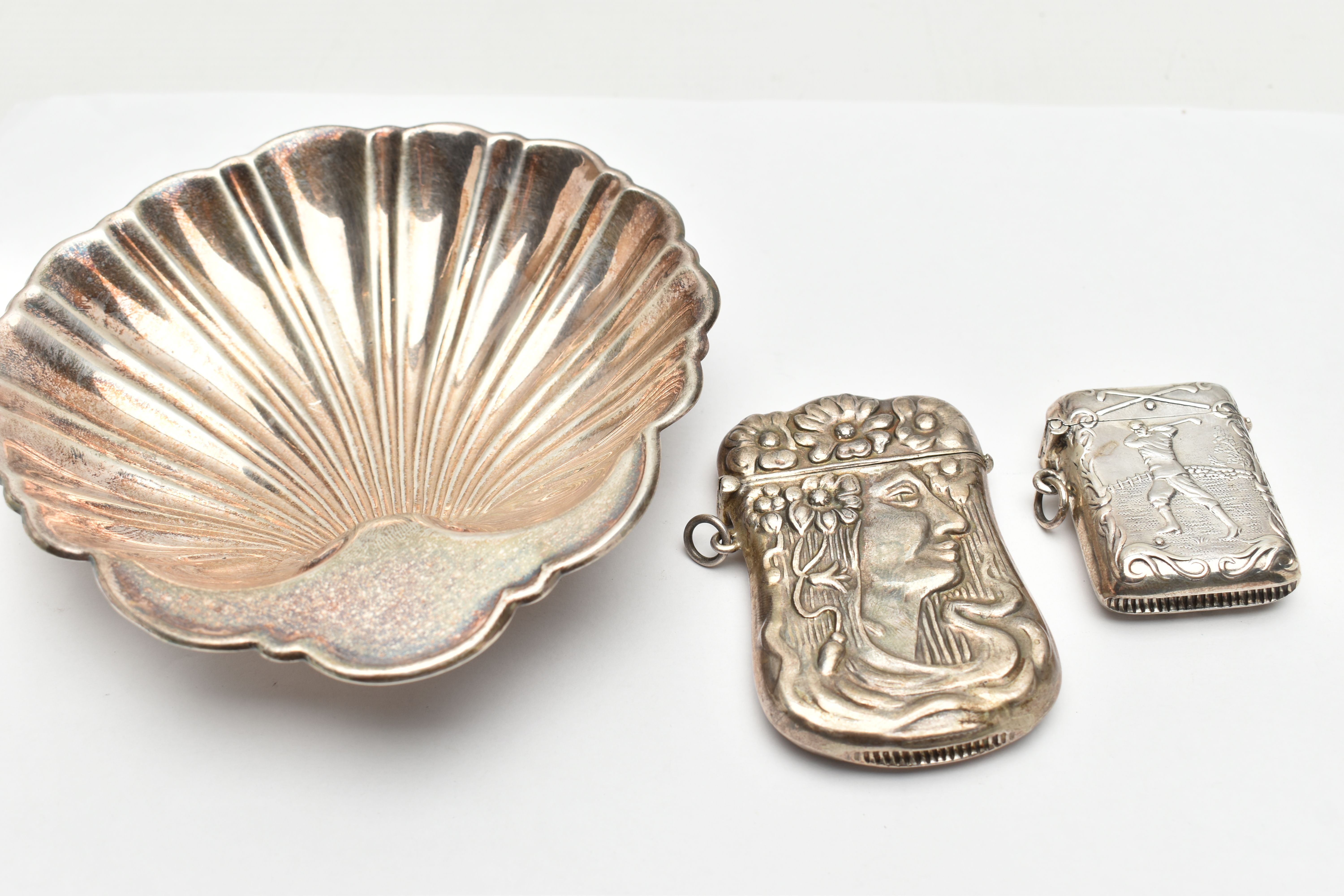 A STERLING SILVER SHELL SHAPED DISH AND TWO VESTA CASES STAMPED 925, the dish on three ball feet,