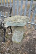 A SANDSTONE STADDLE STONE and a matched top, length 54cm x depth 36cm x height 69cm