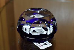 A FRENCH BACCARAT ZODIAC FACETED GLASS PAPERWEIGHT, with a cobalt blue base and central white '