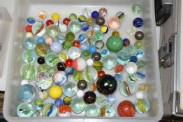 A TRAY OF GLASS MARBLES, various colours and sizes