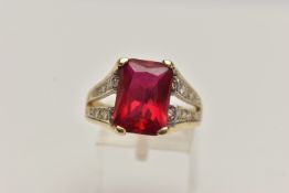 A SYNTHETIC RUBY AND DIAMOND DRESS RING, designed as a central rectangular synthetic ruby in a